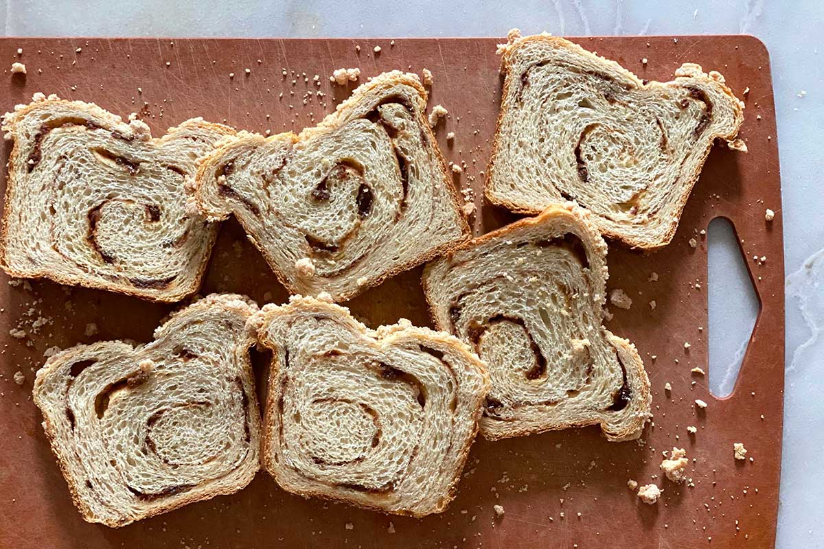 A few slices of homemade cinnamon swirl bread on a cutting board