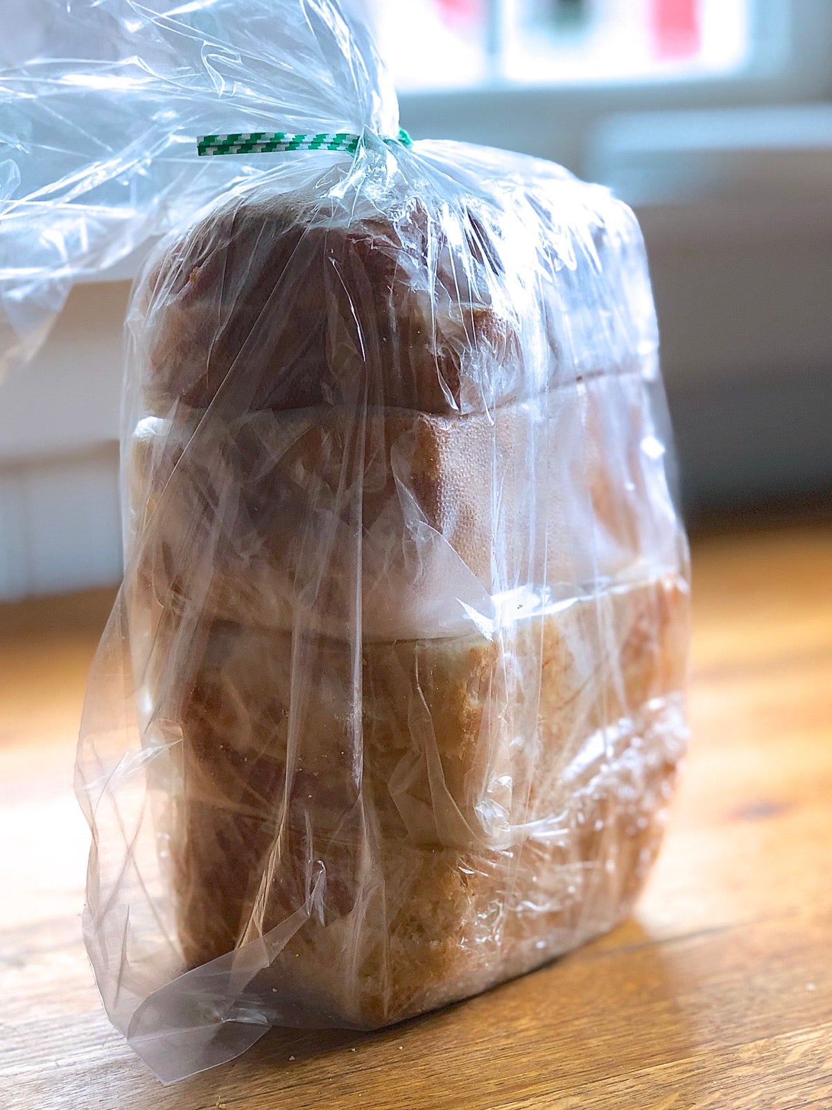 Individual packets of sandwich bread stored in a plastic bag, ready for the freezer.