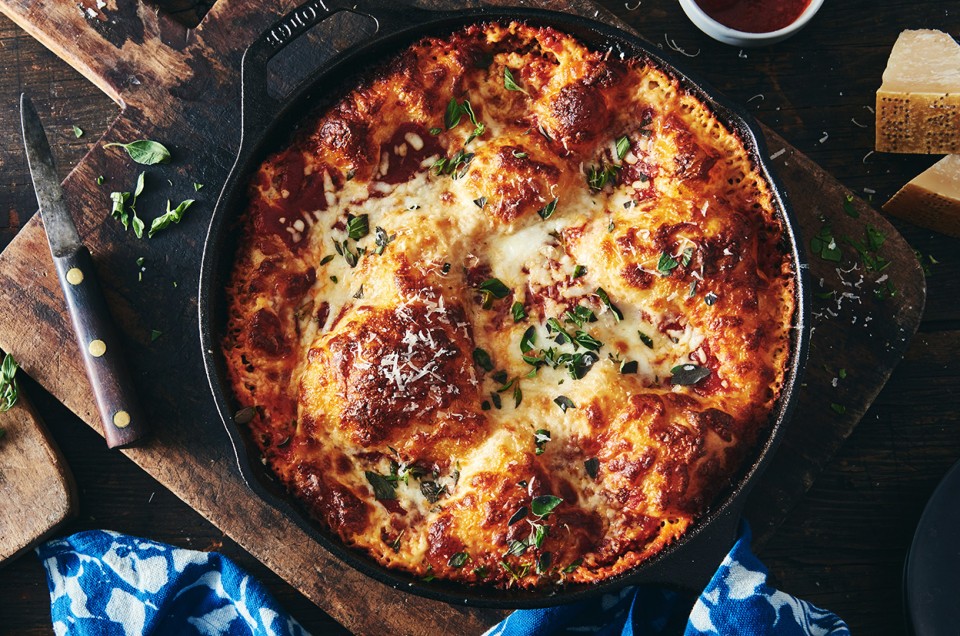 Crispy Cheesy Pan Pizza overhead in a cast iron pan - select to zoom