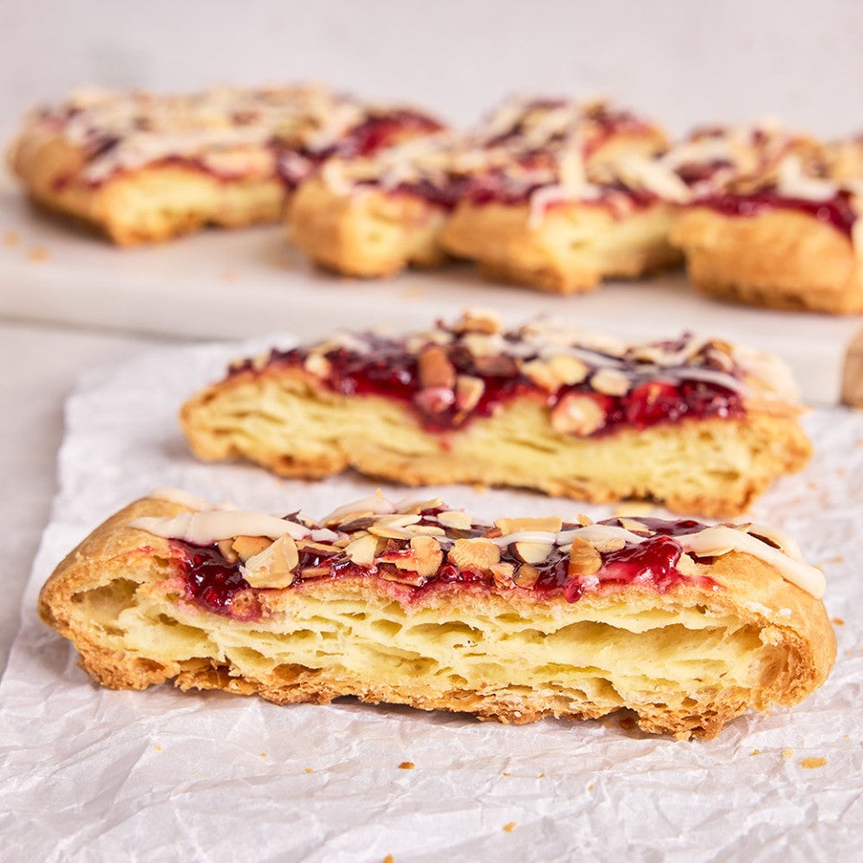 Almond Puff Loaf sliced and shown on parchment