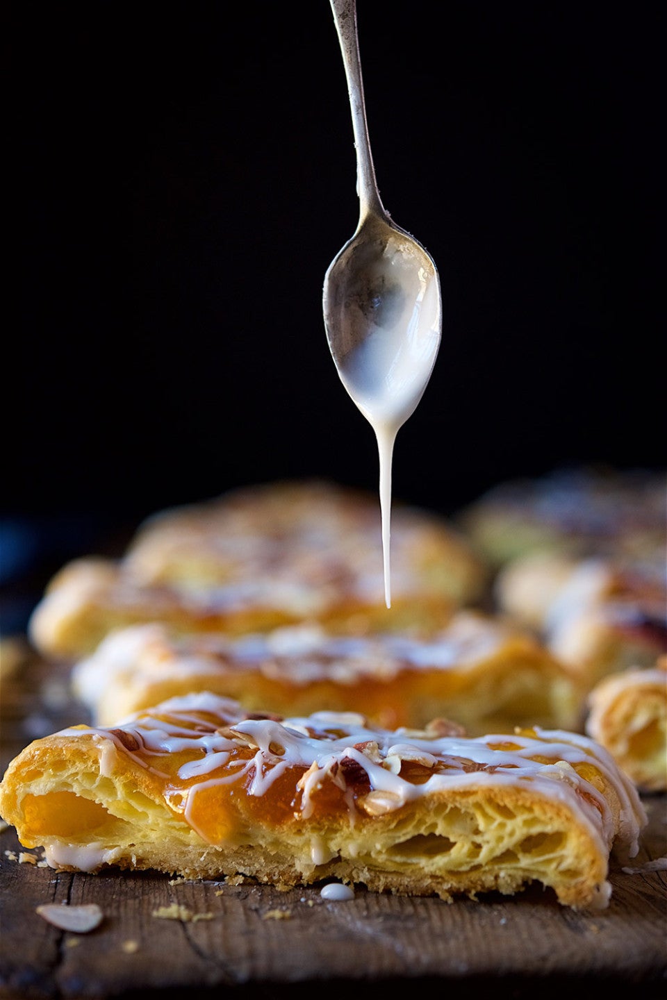Drizzling icing onto an Almond Puff Loaf
