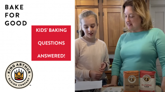 Grace and Amy reading questions in kitchen