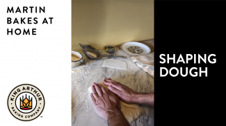 Hands shaping bread dough