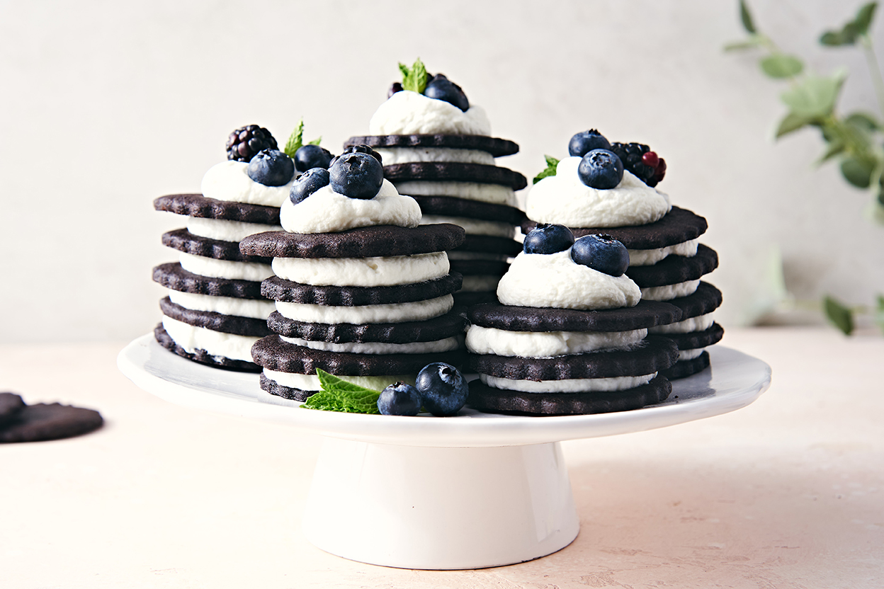 Chocolate wafer cookies stacked and layered with whipped cream