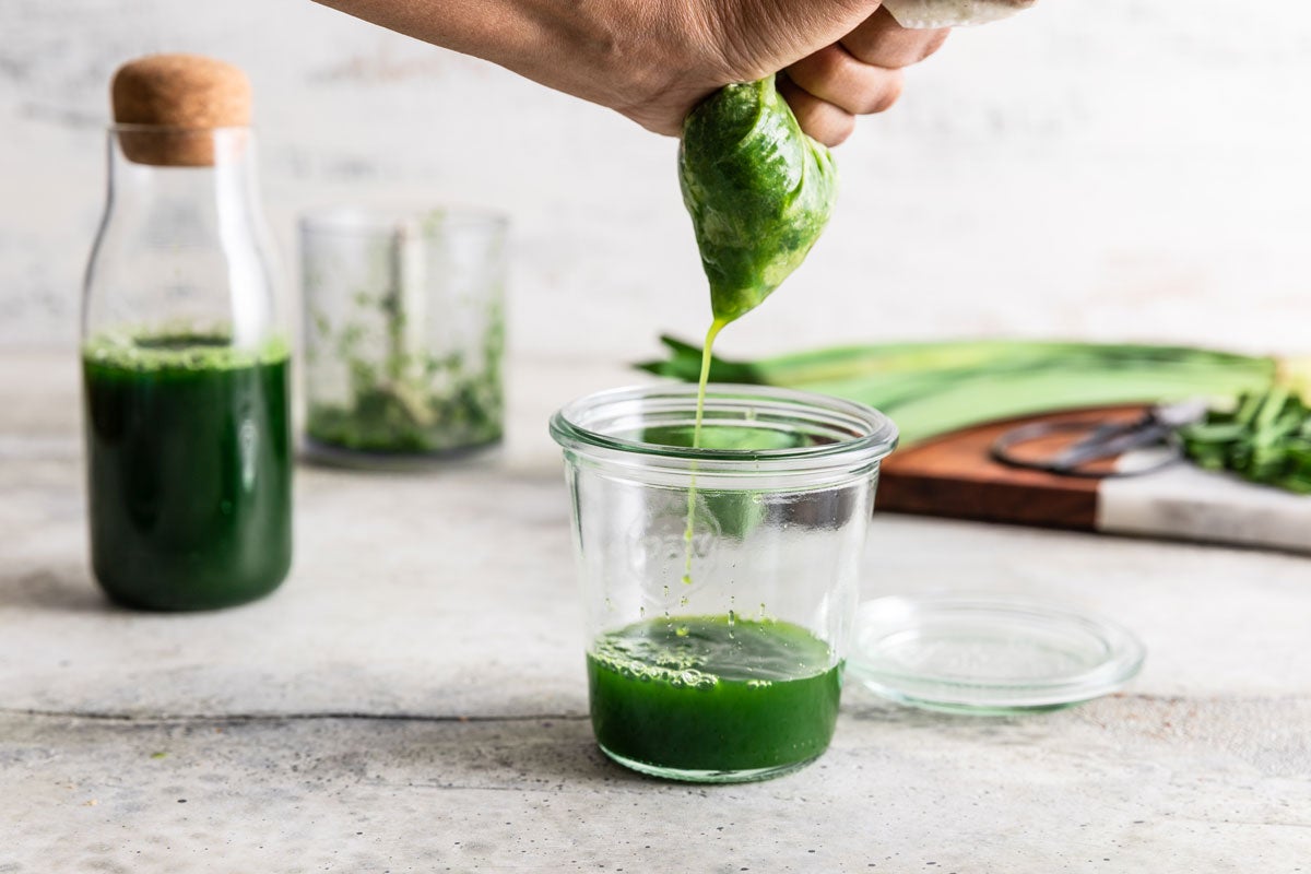 Pandan being strained to make extract