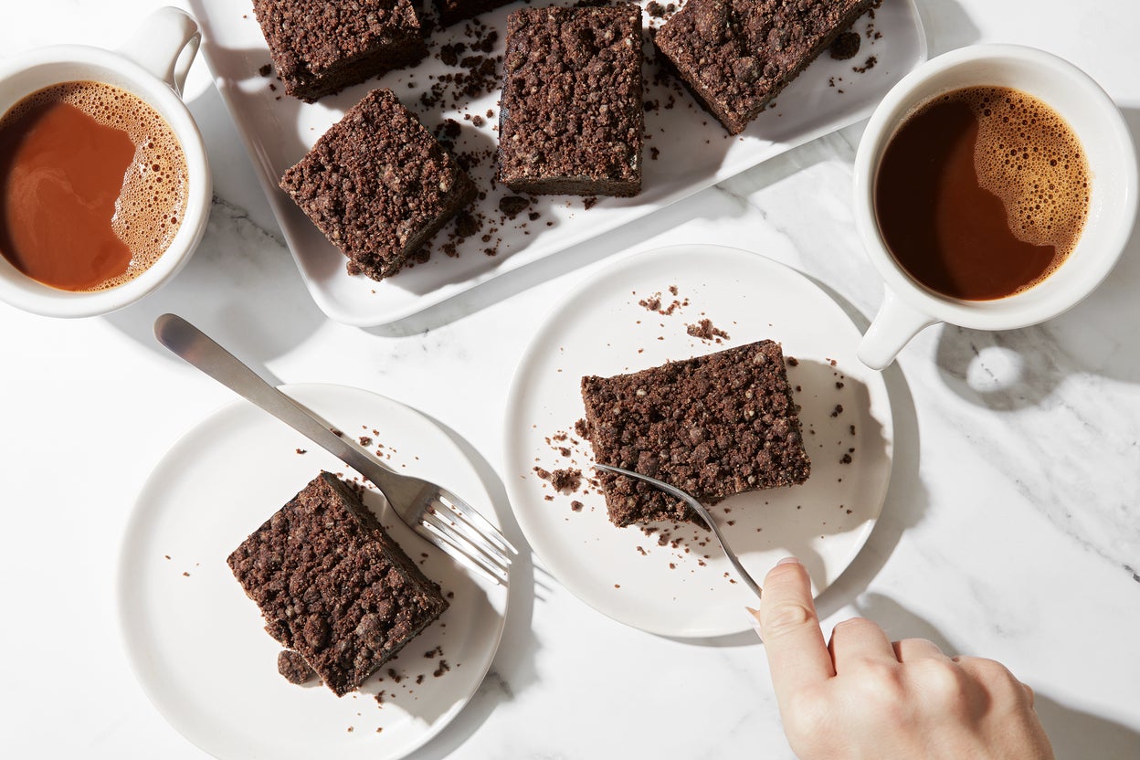 A breakfast scene with coffee and slices of rye chocolate coffeecake