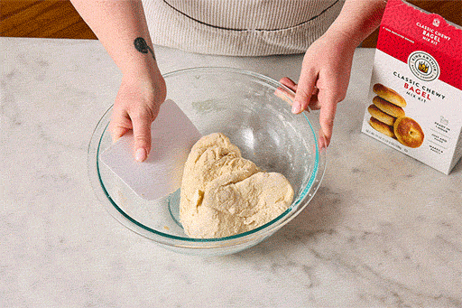Animated gif showing how to fold, mix, and kneed bagel dough.