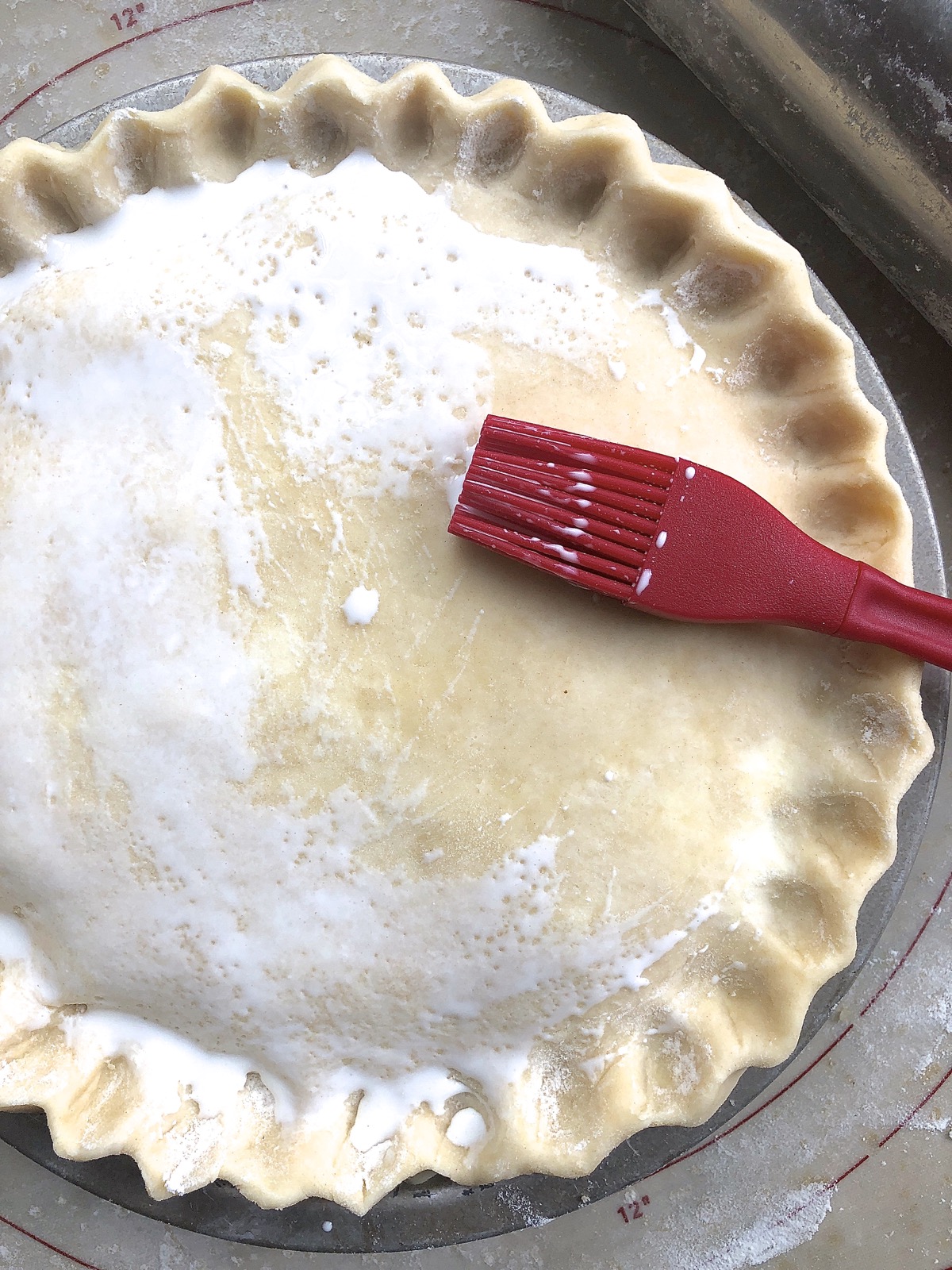 Unbaked pie brushed with milk to help browning in the oven