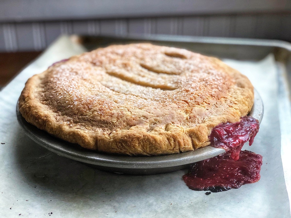 Baked pie made with super-flaky pie crust showing puffed-up crust