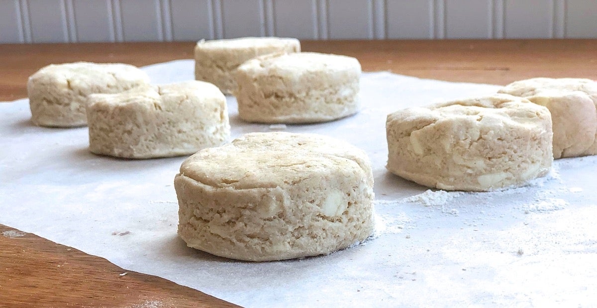 Shaped biscuits on a piece of parchment showing their clean-cut sides.