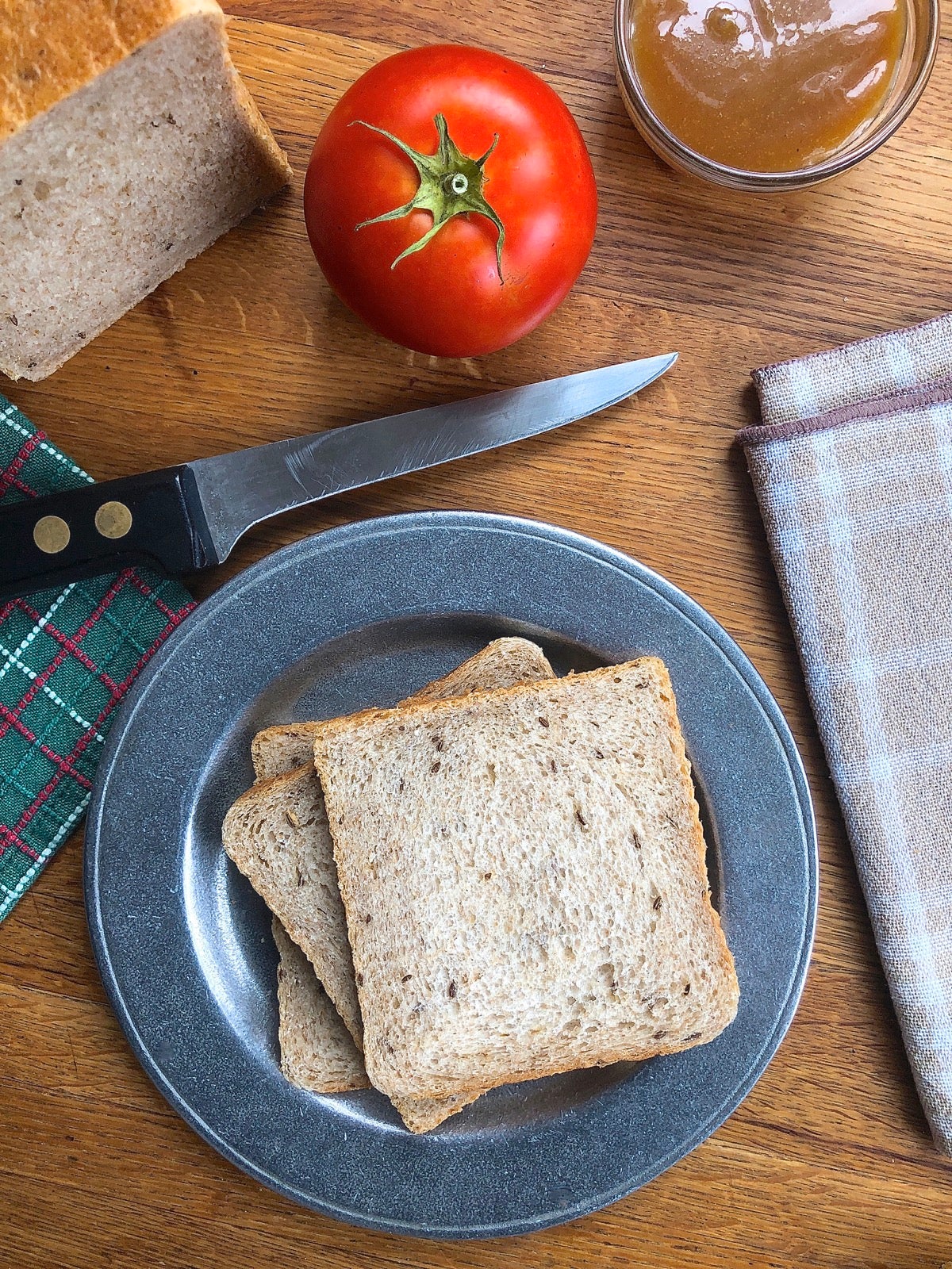 Sliced rye bread on a plate, ready to make into a sandwich.