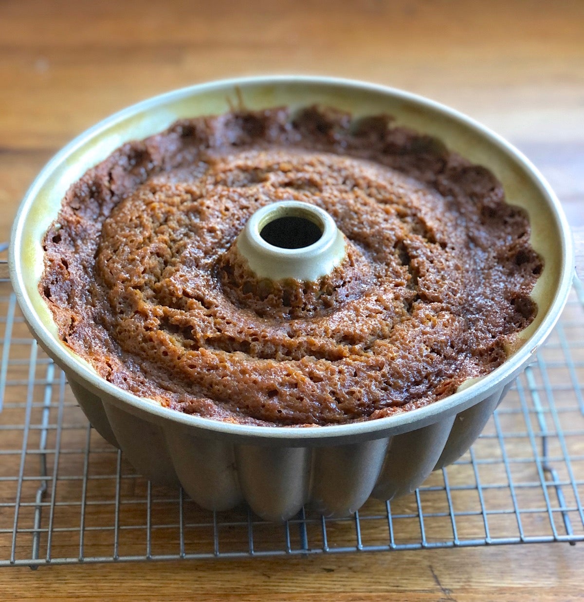 Flat, fallen gingerbread cake in a bundt pan.