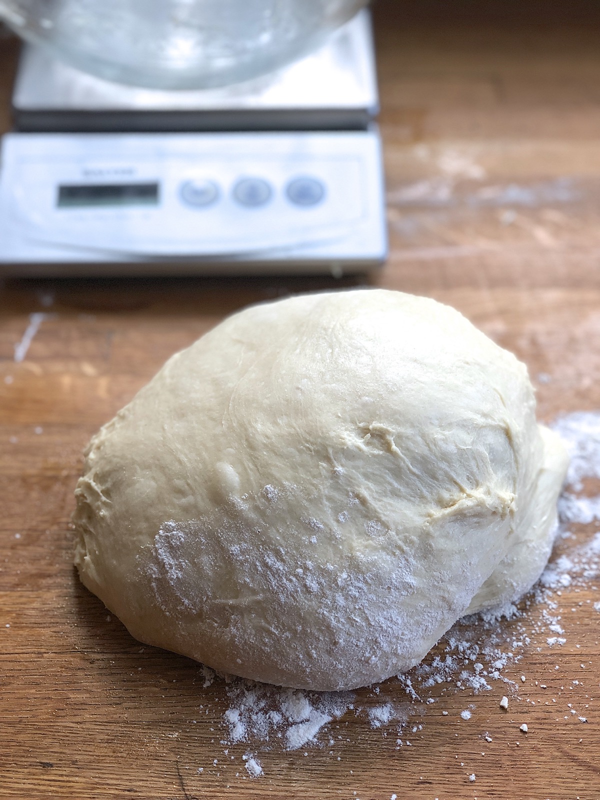 Kneaded dough for Amish Dinner Rolls on a lightly floured work surface.