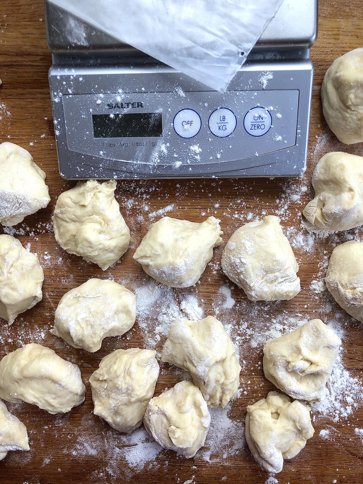 Dough for Amish Dinner Rolls divided into 24 pieces using a scale.