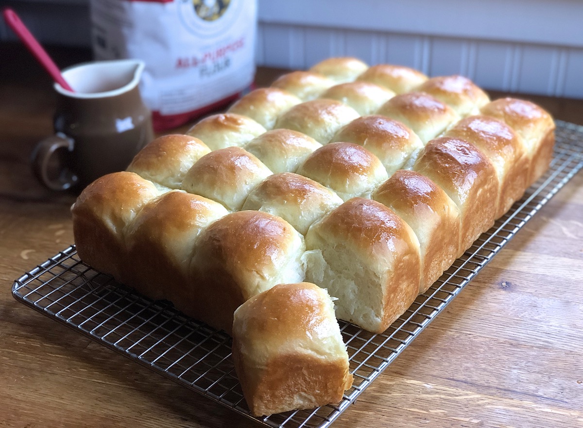 Amish Dinner rolls hot from the oven, cooling on a rack.