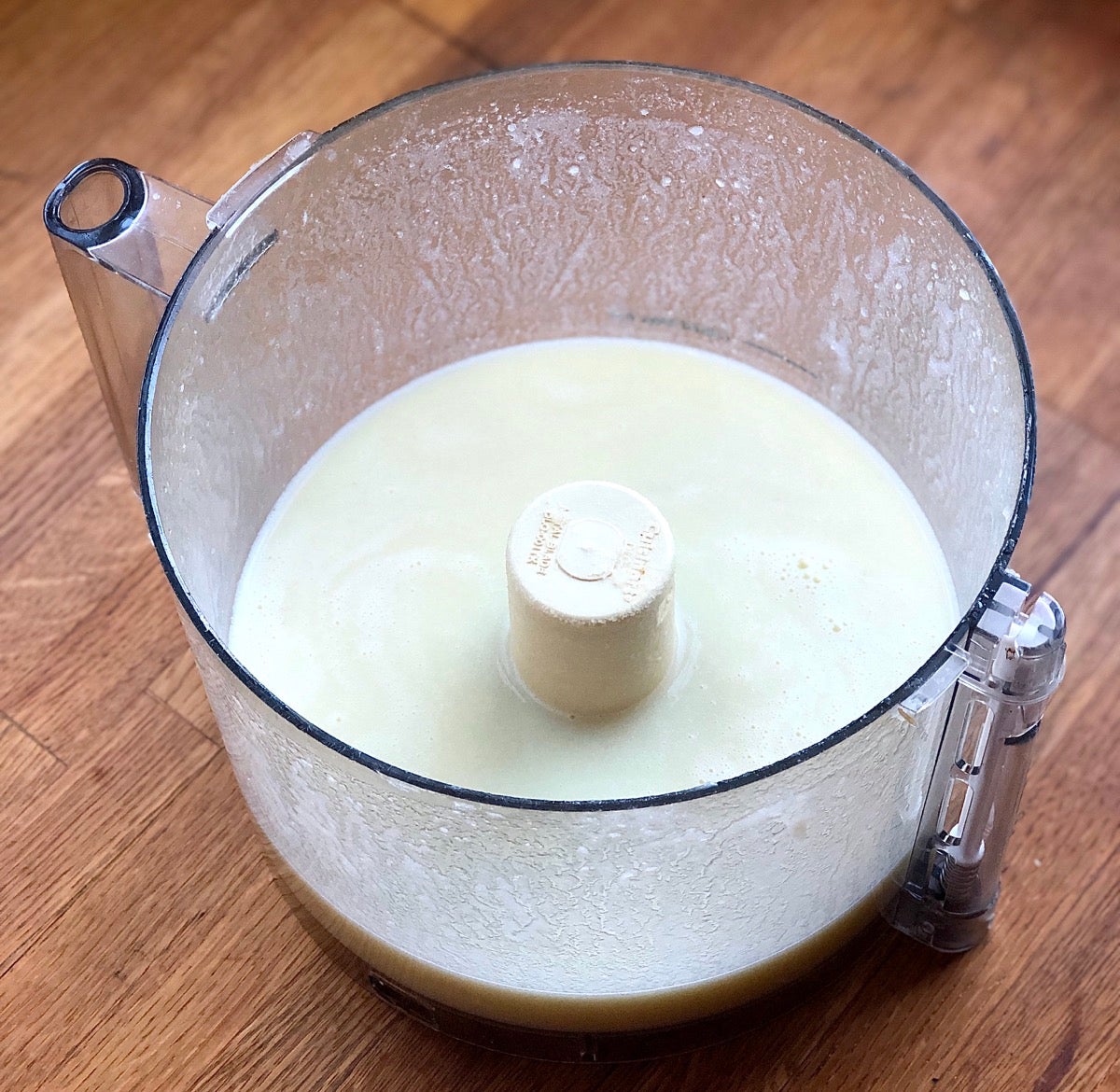 Potato chunks, hot water, sugar, salt, and butter in the bowl of a food processor, processed into a purée