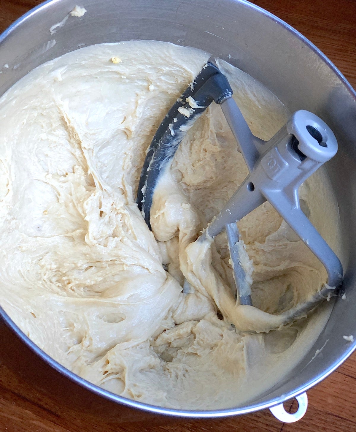 Dough for Amish Dinner Rolls in a stand mixer bowl, ready to be kneaded.