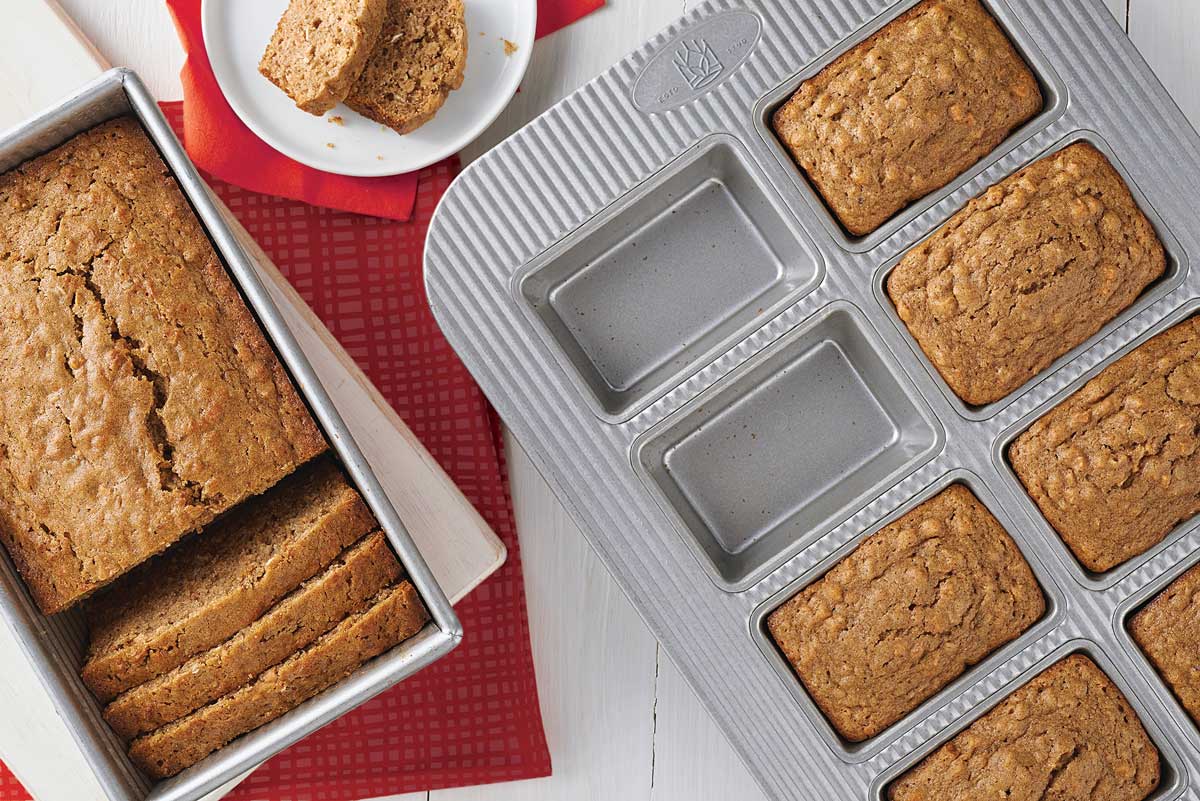 Full sized quick bread next to loaves baked in mini loaf pan