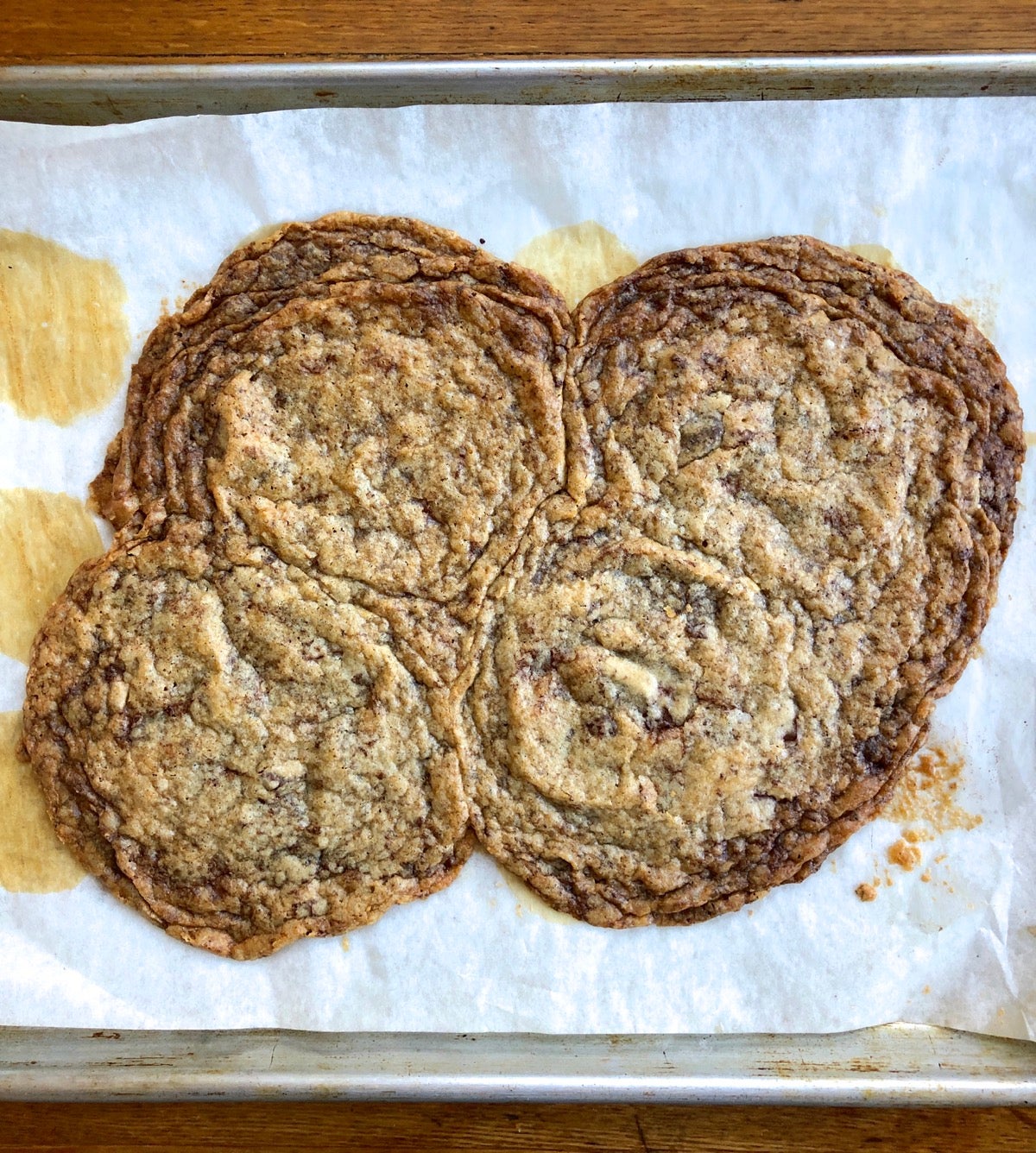 Chocolate chip cookies spread into a solid puddle of cookie on baking sheet.