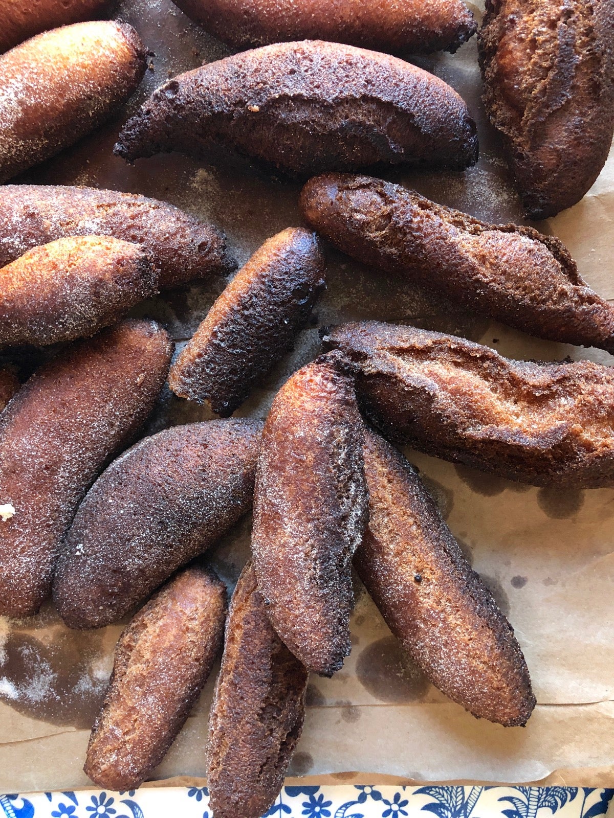 Burned crullers on a baking sheet.