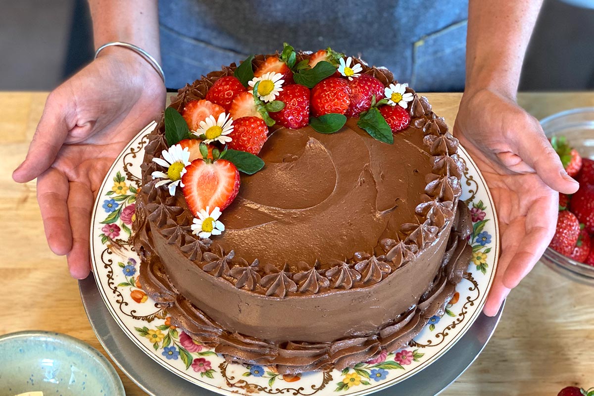 A chocolate sheet cake decorated with edible flowers