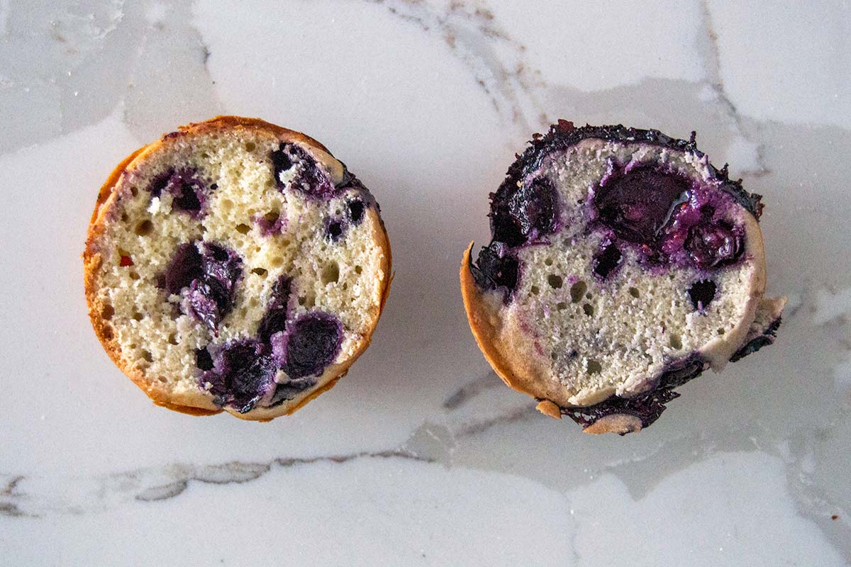 Golden blueberry muffin on right, blueish blueberry muffin on left