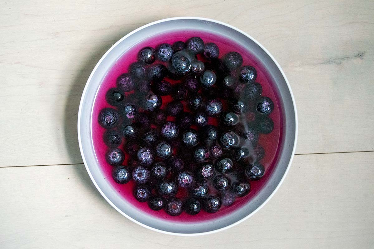 Bowl of frozen blueberries in water