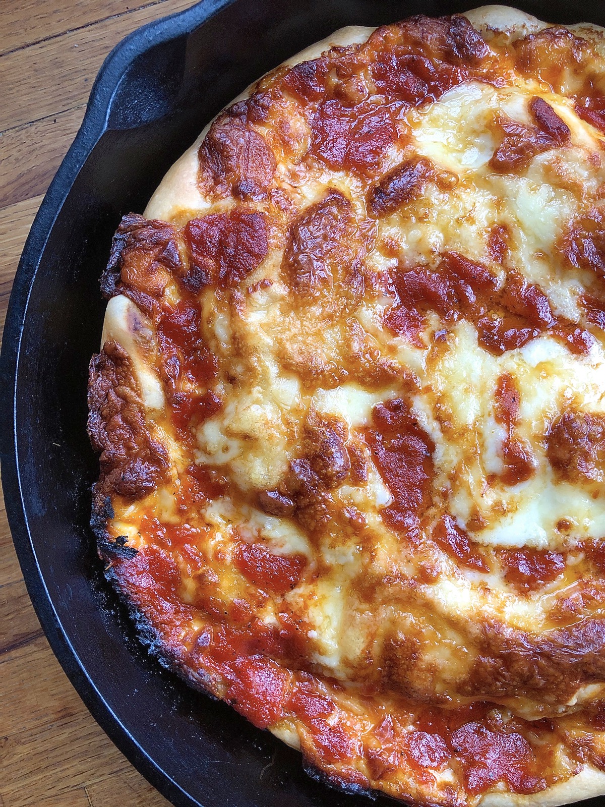 Pizza baked in a cast iron pan, hot from the oven.