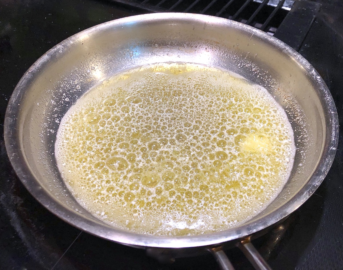 Butter sizzling in a shallow skillet.