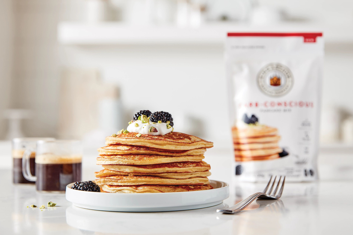 Carb-Conscious Pancake Mix packaging with pancakes in the background