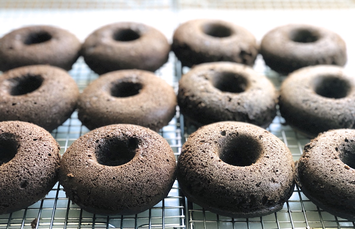 Chocolate Fudge Cake Doughnuts cooling on a cooling rack.