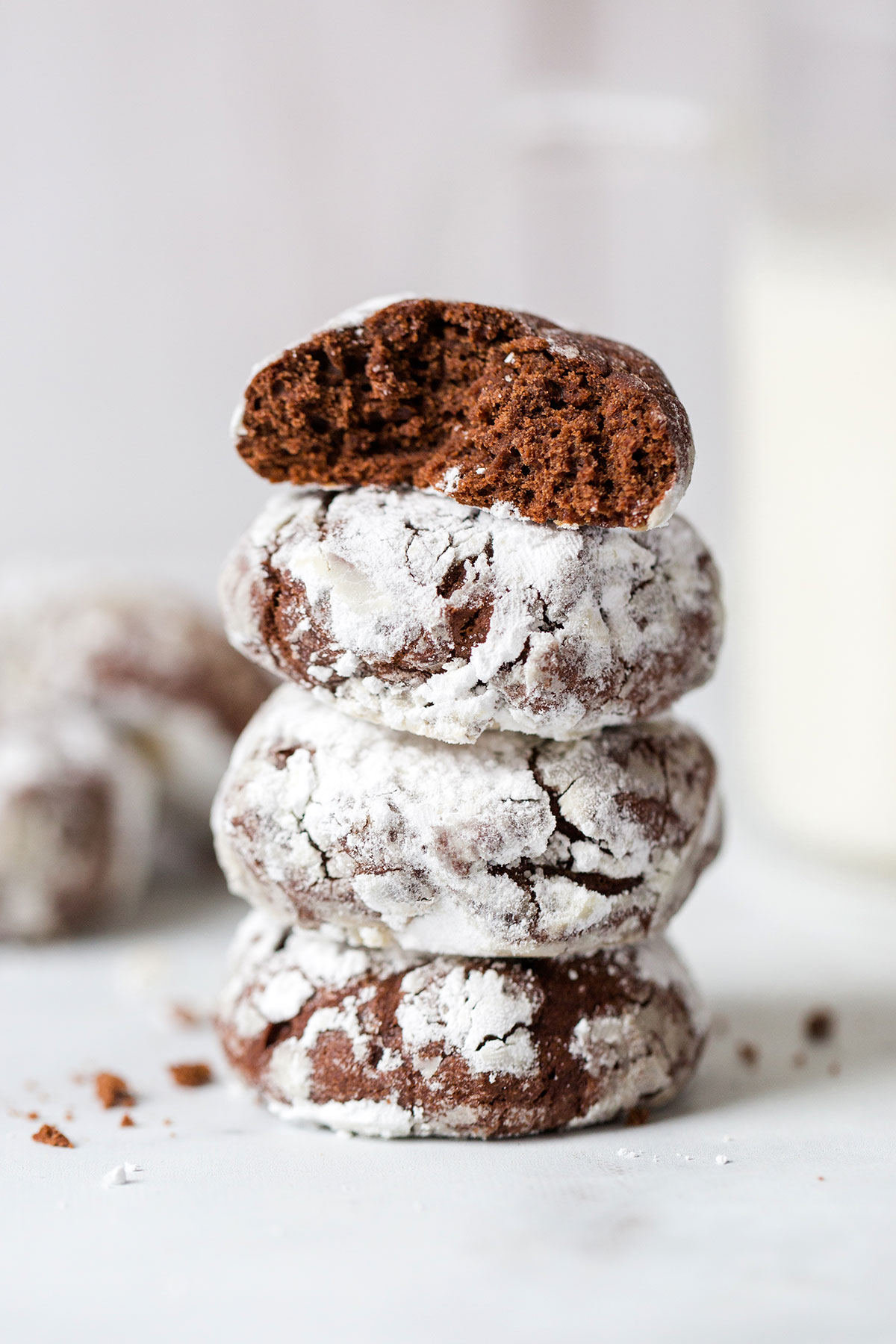 A stack of Chocolate Crinkles with the top cookie broken open to reveal the fudgy interior