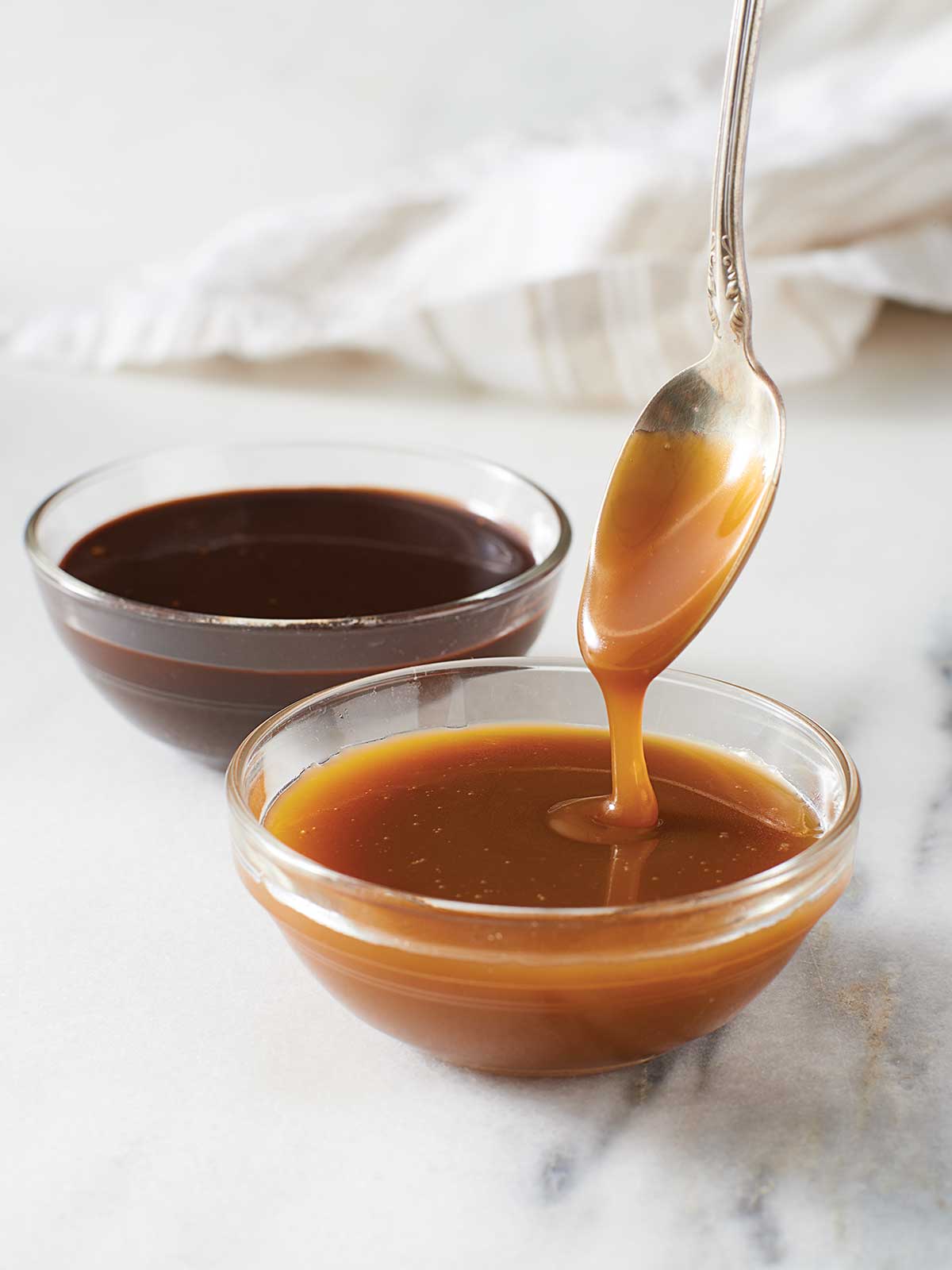 Bowls of hot fudge and caramel sauce