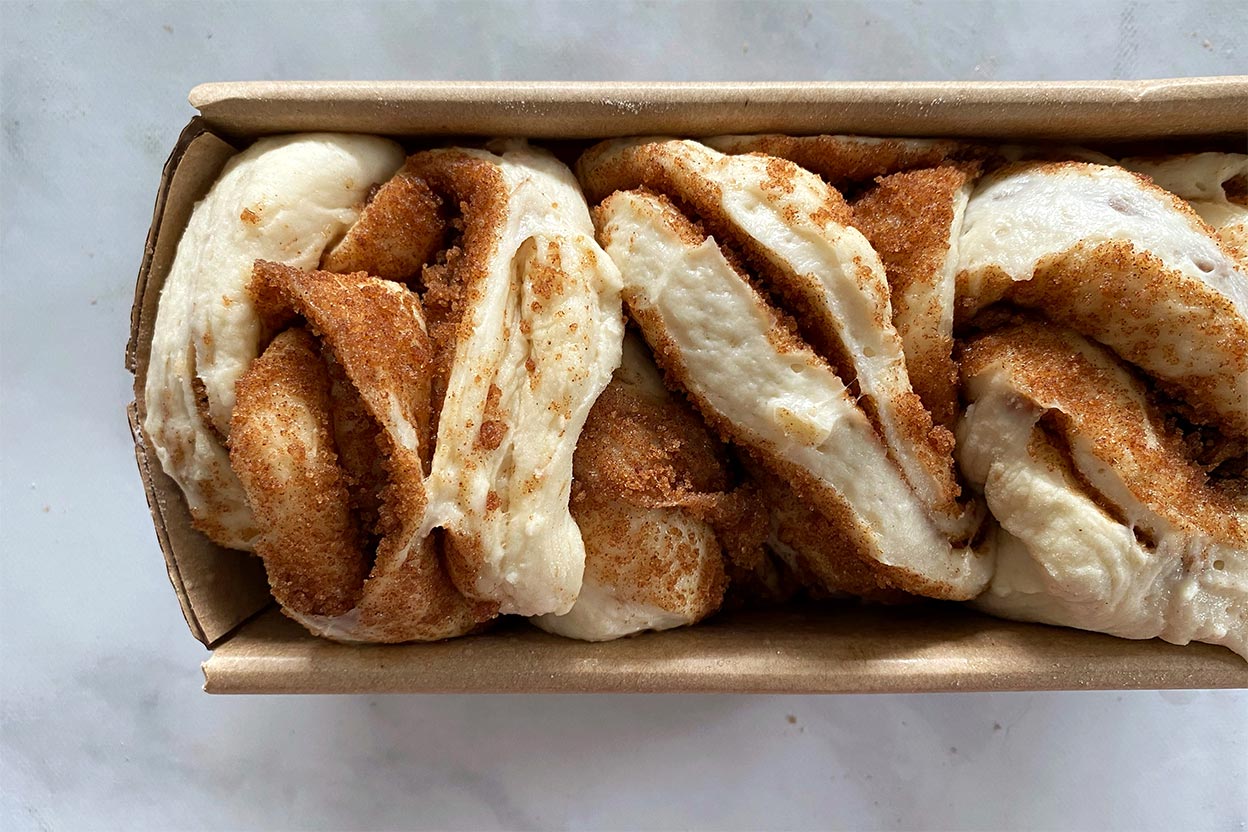 A loaf of cinnamon bun bread shaped like a babka