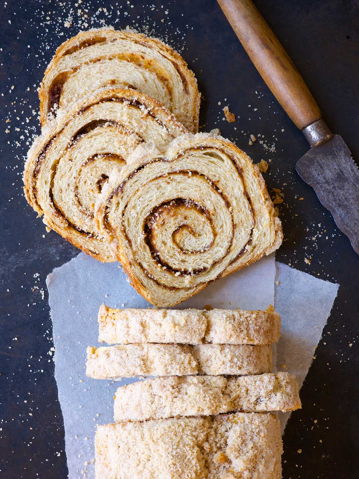 A loaf of streusel-topped cinnamon swirl bread cut into slices