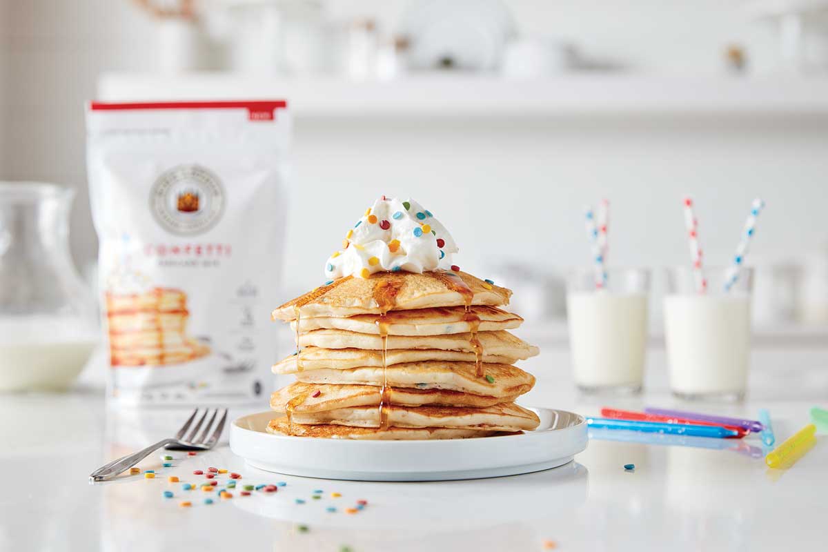 Stack of pancakes with confetti mix package in background