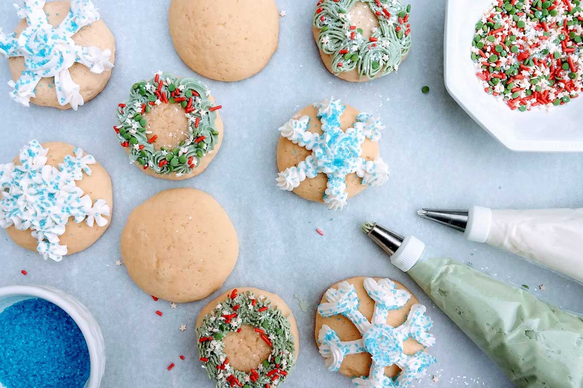 Cookies decorating with piped wreaths and snowflakes