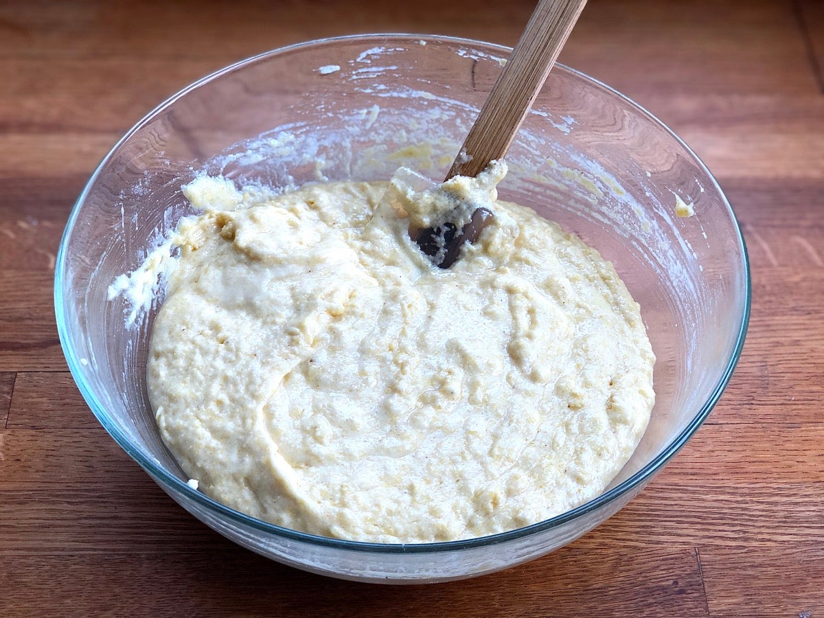 Stirring liquid and dry ingredients together in a bowl