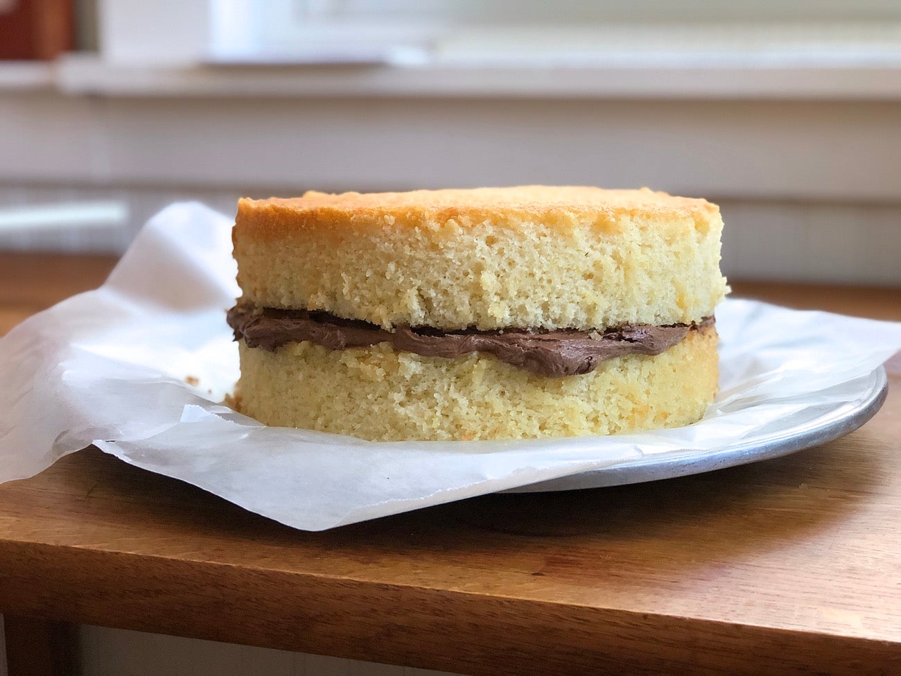 Double-layer yellow cake with chocolate frosting in the middle.