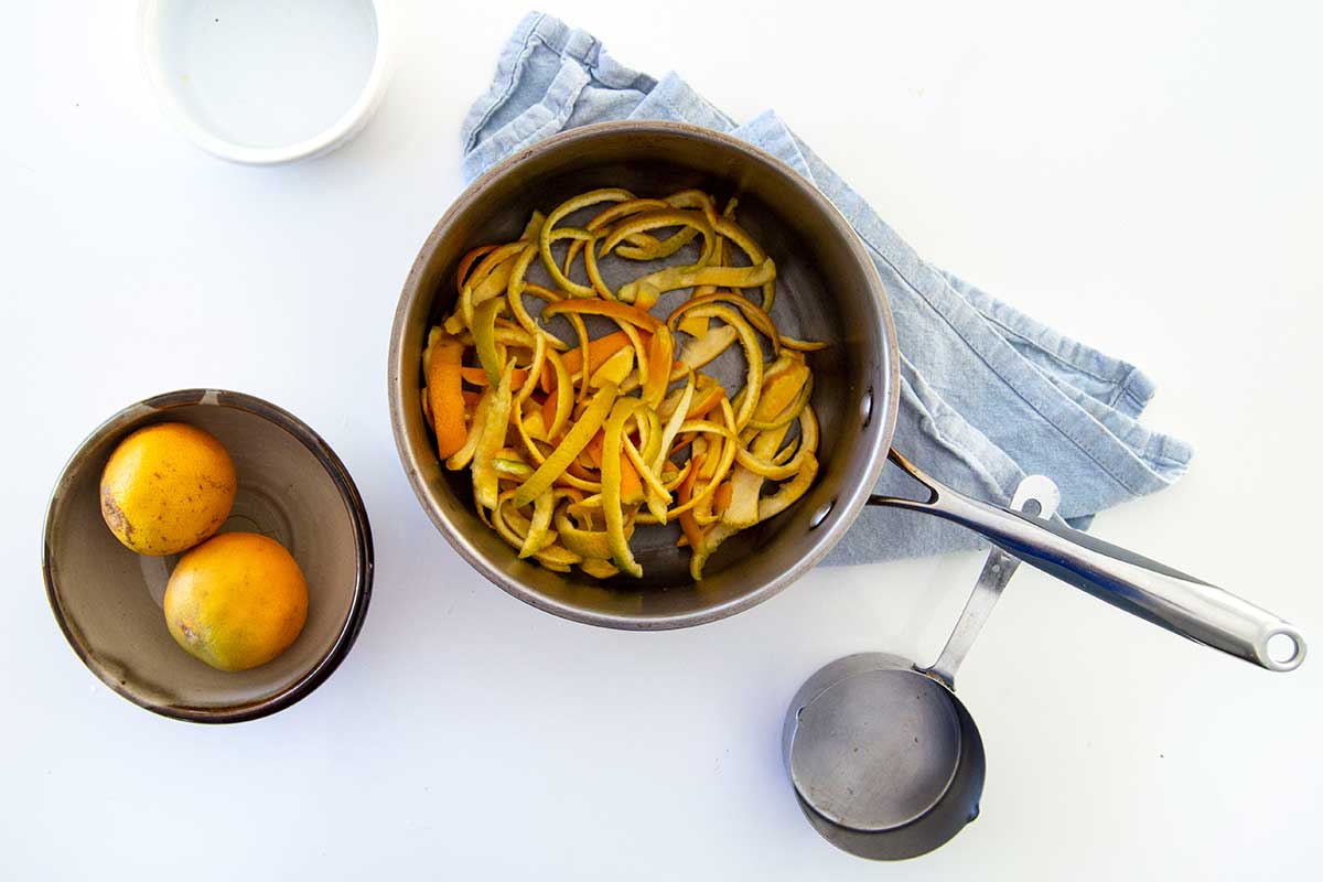 Saucepan with sliced orange peels