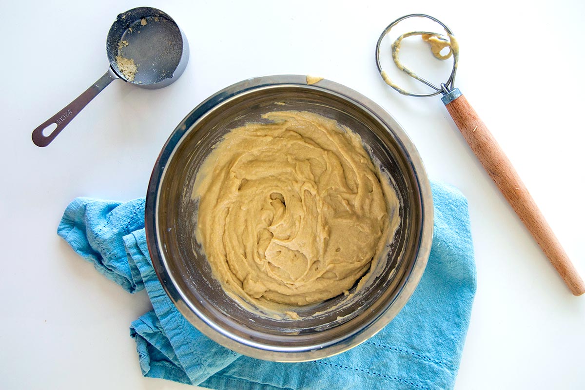 Dough whisk next to pancake batter