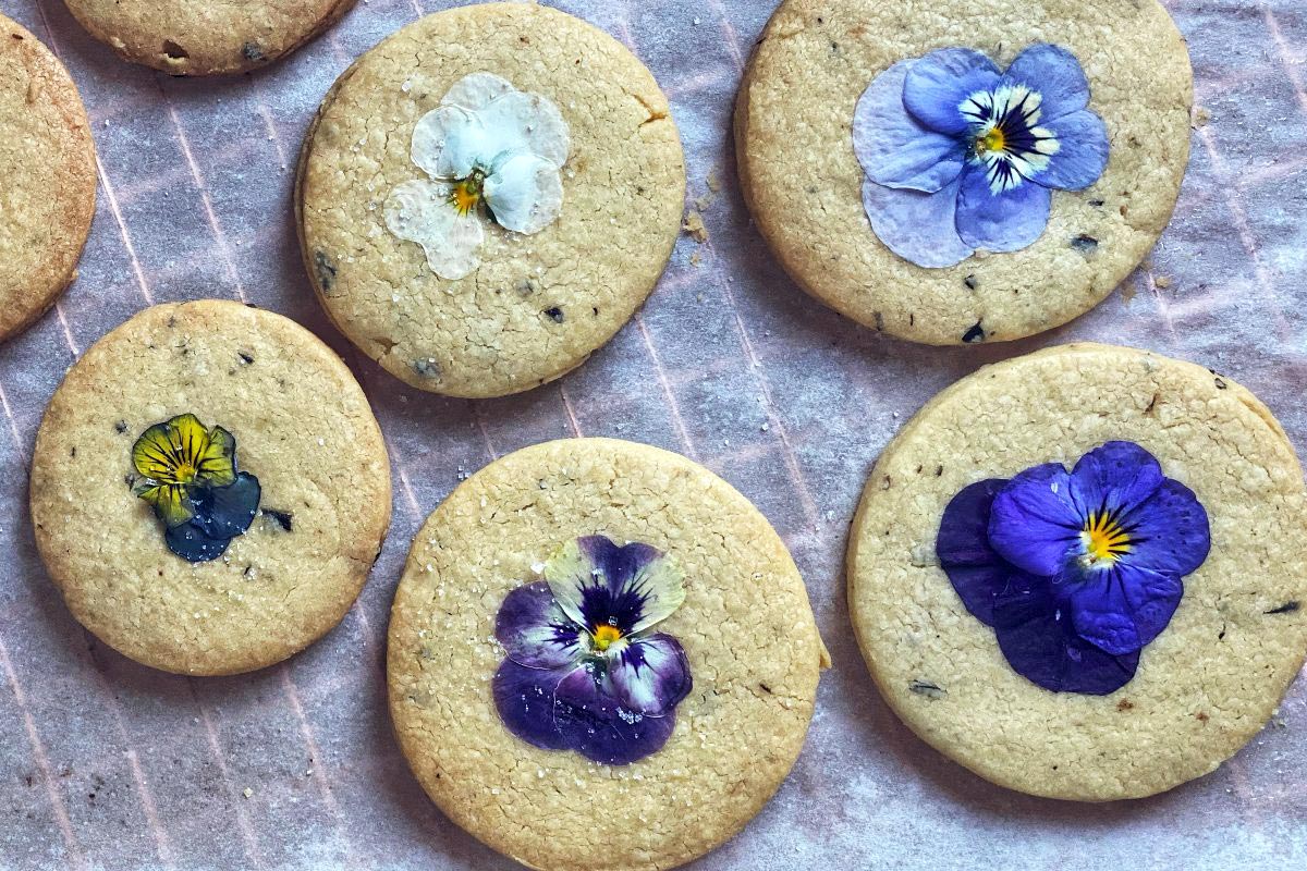 Rosemary shortbread cookies with edible flowers pressed into the tops