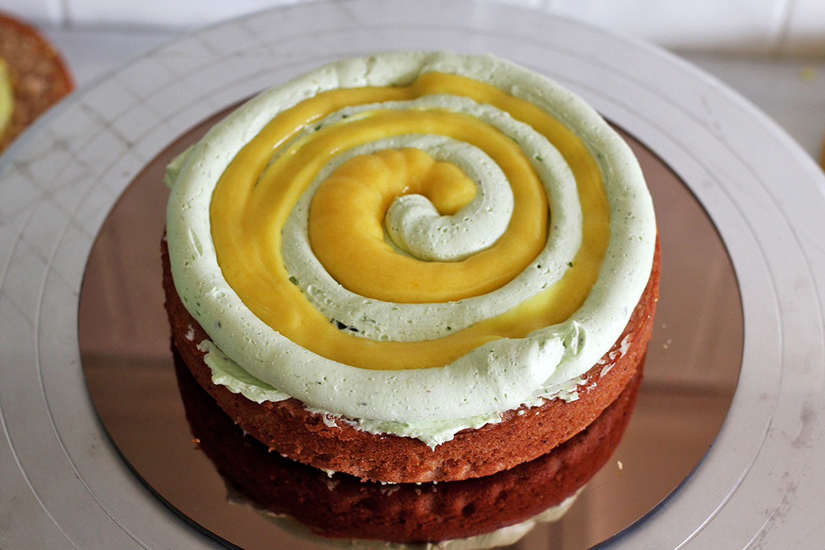 Cake layer with spiral of piped curd and buttercream 