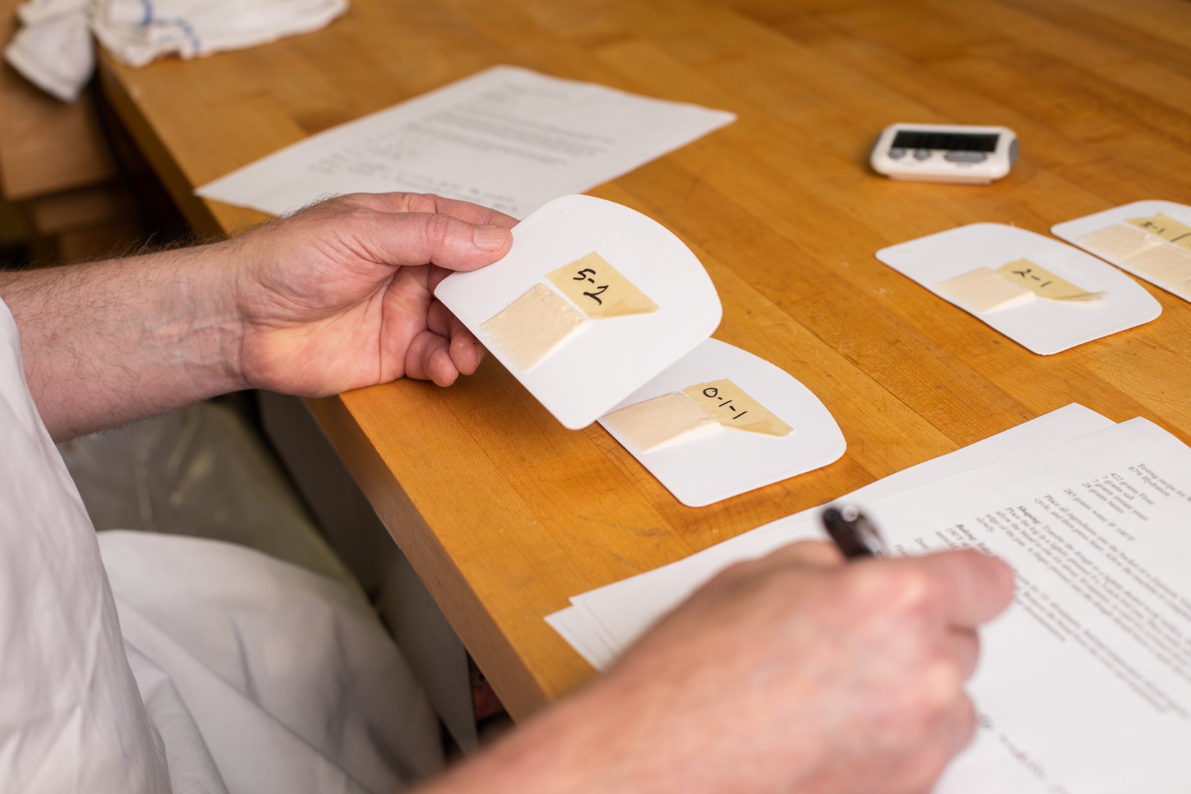 Frank takes notes about each flour slick in King Arthur's test kitchen