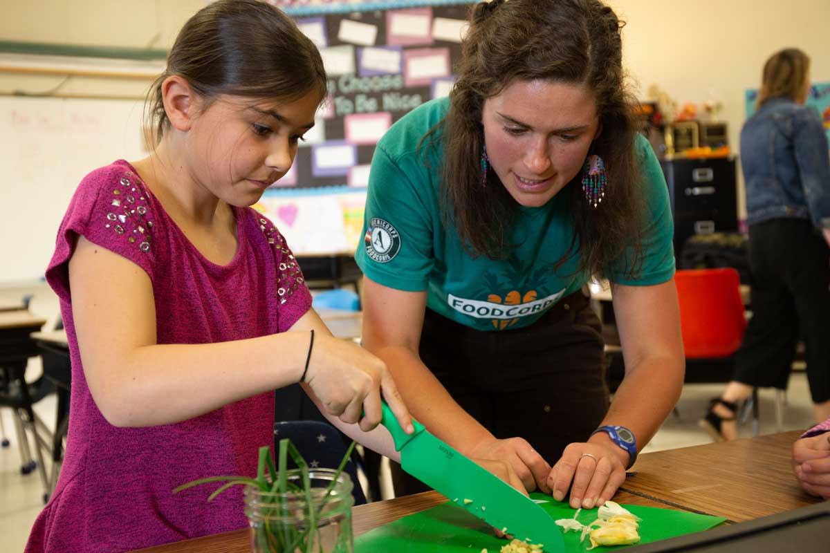 FoodCorps instructor cooking with student