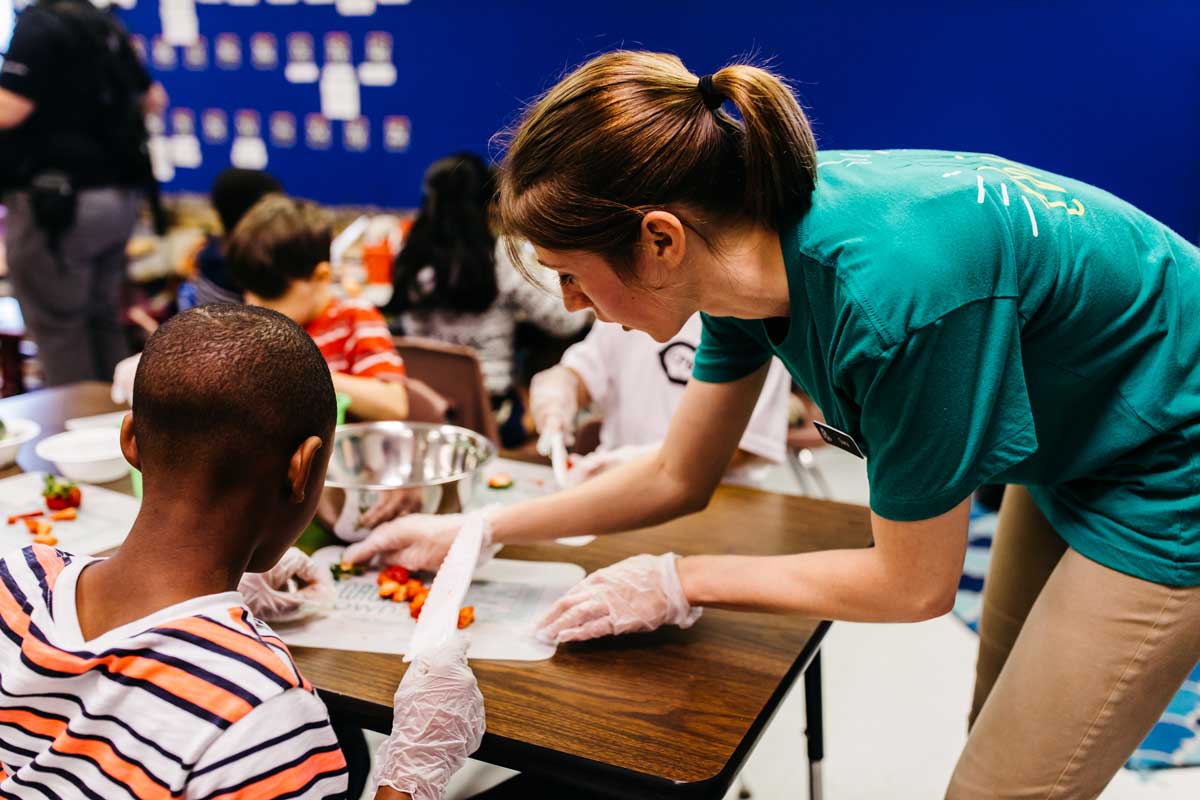 FoodCorps instructor cooking with student