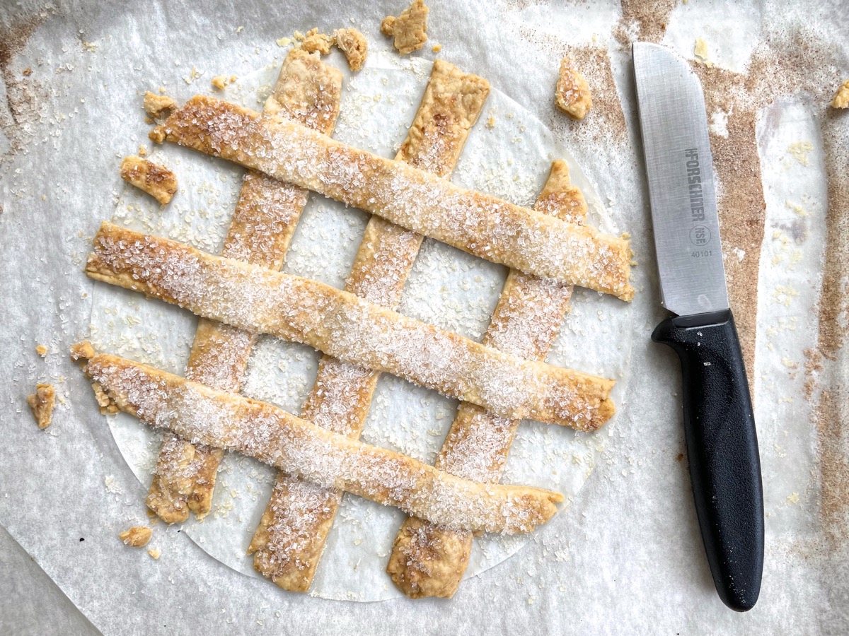 A woven lattice on parchment, sprinkled with sugar and baked until golden.