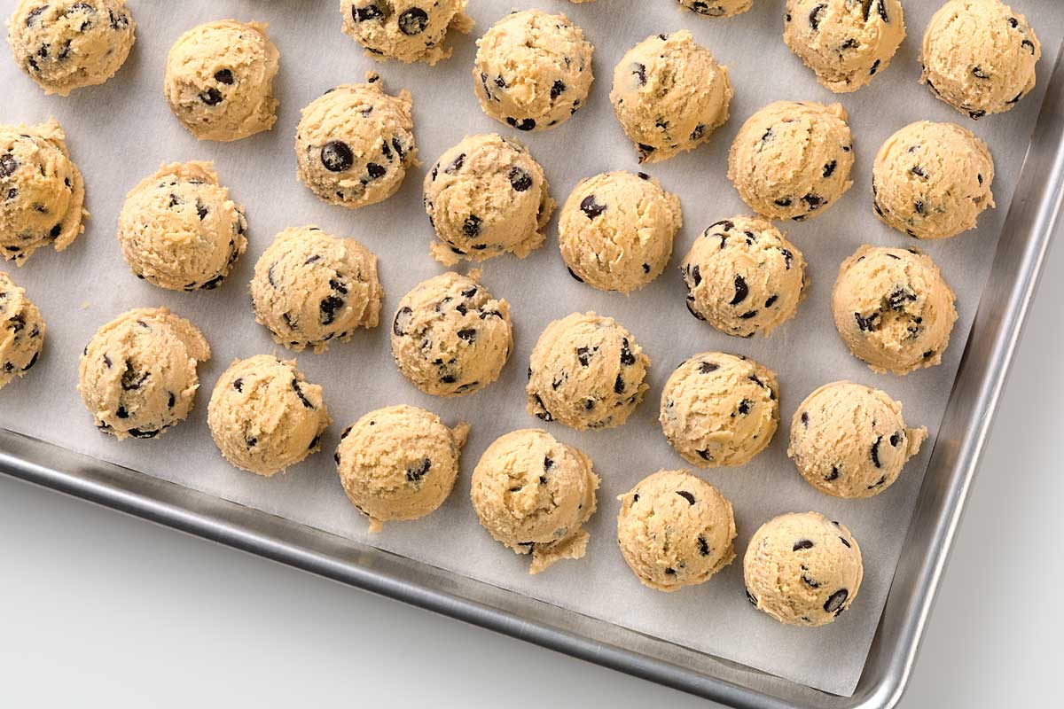 Unbaked cookie dough on parchment-lined sheet pan