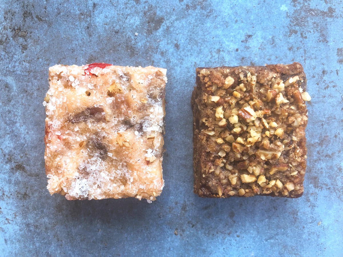 To squares of fruitcake on a piece of slate: one dark, one light.