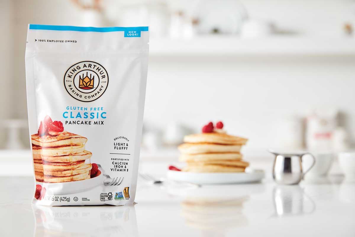 Stack of pancakes with gluten-free mix package in background